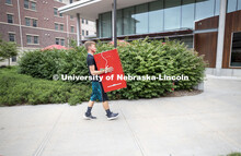 Jeremy Schepler of Wilcox, Nebraska, carries a refrigerator into Knoll Residence Hall. Jeremy is a f