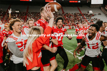 Student making a catch and the team going wild, she was the only one to catch the ball. Students got