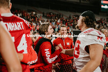 Football players meeting fans and students. Student making a catch and the team going wild, she was 
