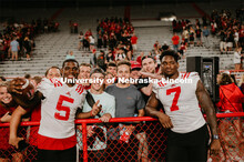 Football players meeting fans and students. Student making a catch and the team going wild, she was 