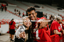 Football players meeting fans and students. Student making a catch and the team going wild, she was 