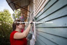 First year law students, faculty and staff paint two Lincoln houses. The painting is a yearly tradit