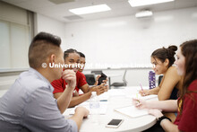 Justin Nguyen (left) talks with freshmen Matthew Brown (second from left) and Cleopatra Babor (secon