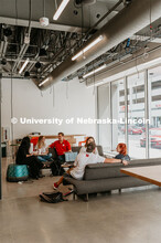 Students studying and socializing by the window in the Johnny Carson Center for Emerging Media Arts.