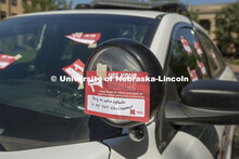Students sign a "Use Your Voice" pledge and affix them to a police car during the September 10 Cover