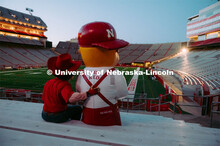 Herbie and Lil' Red sitting in the bleachers. Herbie Husker photo shoot, pictured throughout Memoria