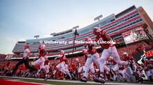 Coach Scott Frost leads his team onto the field for the Nebraska vs. Northern Illinois football game