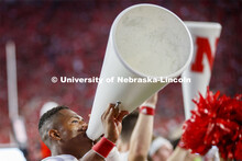 Ramarro Lamar, one of the male cheerleaders, leads the crowd in a cheer. Nebraska vs. Northern Illin