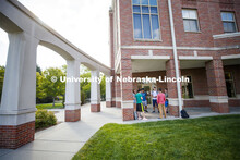Students hanging out front of the Kauffman Academic Residential Center. Raikes school photo shoot. S