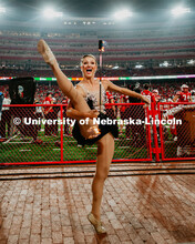 Twirler Kimberly Law twirling with batons lit on fire. Nebraska vs. Ohio State University football g