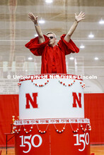 Chancellor Ronnie Green wearing the robe of the Innocents pops out of the N150 birthday cake. Showti