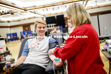 Zak Folchert, junior from North Platte, donates blood at the ASUN blood drive. Bleed Husker Red: Glo