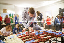 Mason Suey pomps his homecoming display. The floor of Phi Delta Theta fraternity is filled with stud