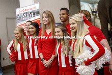 Debra Kleve White, alumni and former member of then-named yell squad, poses with the current cheer s