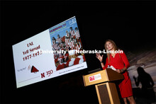 Debra Kleve White, alumni and former member of then-named yell squad, presents the Homecoming Nebras