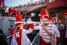 Band members high-five as they pass one another. Nebraska vs. Northwestern University football game.