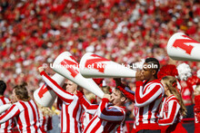 The male cheerleaders use their megaphones to rally the crowd. Nebraska vs. Northwestern University 