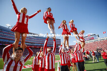 The Cheer Squad perform stunts at the Nebraska vs. Northwestern University football game. Homecoming