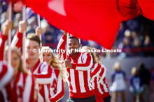 The Cheer Squad run across the field carrying flags that spell NEBRASKA. Nebraska vs. Northwestern U