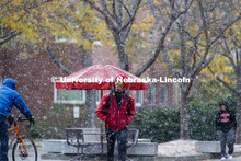 Paul Muragizi, senior in sociology from Lincoln, walks across the plaza during the snow. Snow on cam