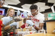 Lily Bruner and Terrol Wilson draw up liquids in a Chem 109 lab to determine absorption spectra and 