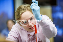 Emmalise Meyer draws up liquids in a Chem 109 lab to determine absorption spectra and best wavelengt