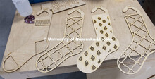 Carly Brotherson pulls sock blocks from the laser cutter at Nebraska Innovation Studio Nov. 25. Brot