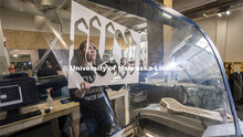 Carly Brotherson pulls sock blocks from the laser cutter at Nebraska Innovation Studio Nov. 25. Brot