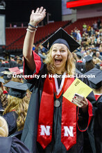 Molly Lambert waves to family and friends as she enters the arena. December Undergraduate commenceme