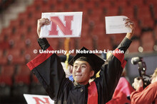 Dat Nguyen shows off his Engineering degree to family and friends December Undergraduate commencemen