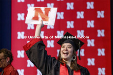 Kylie Tucker shows off her diploma to family and friends. December Undergraduate commencement at Pin