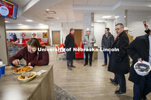 Ryan Lahne, interim director of the east campus union, (at center, wearing hard hat) discusses the n