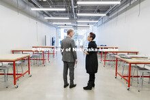 NU President Ted Carter listens as Megan Elliott, founding director of the Johnny Carson Center for 