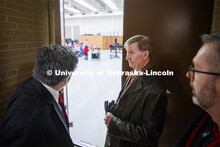 NU President Ted Carter listens as Sergio H. Ruiz, Director of the Glenn Korff School of Music and P