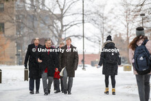 UNL Chancellor Ronnie Green and NU President Ted Carter walk across city campus during a winter-wind