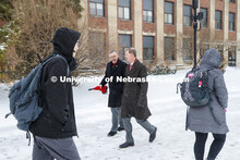 UNL Chancellor Ronnie Green and NU President Ted Carter walk across city campus during a winter-wind