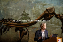 Ross Secord delivers his Nebraska Lecture as a Stegomastodon skeleton stands in the background. Seco