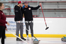 Colin Wooldrik in the purple cap and Adam Schlichtmann in the red and gray cap discuss their next th
