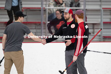 Adam Schlichtmann congratulates a member of the competing team on a match well played. Nebraska's na