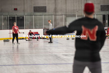 Adam Schlichtmann in the foreground gives instruction to Colin Wooldrik who is about to throw his st