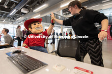 Herbie gets a high-five from a student after they fill out the CEO Action Diversity and Inclusion Pl
