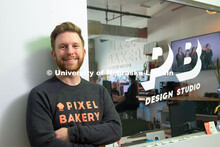 Nebraska alum Jordan Lambrecht stands outside Pixel Bakery Design Studio, which he co-founded in 201