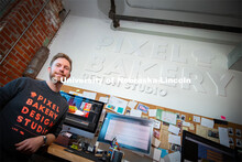 Nebraska alum Jordan Lambrecht stands outside Pixel Bakery Design Studio, which he co-founded in 201