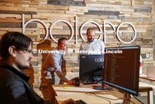 Tim Savage and Joel Brehm look over a project as Corey Svehla (foreground) checks coding. NIC partne