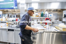 Ron White moves a hot pan of his special recipes through the dining center. Mardi Gras special meal 