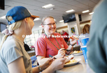 Katie Steffen, junior from Beatrice, eats her crawfish at the Mardi Gras special meal at East Campus