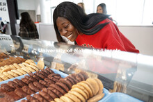 Cather Dining Center photoshoot. A young woman choosing a cookie. March 2, 2020 