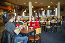 Harper Dining Center photo shoot. Students visit while enjoying their meal at Harper Dining Center. 