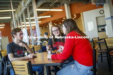 Harper Dining Center photo shoot. Students visit while enjoying their meal at Harper Dining Center. 