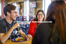 Harper Dining Center photo shoot. Students visit while enjoying their meal at Harper Dining Center. 